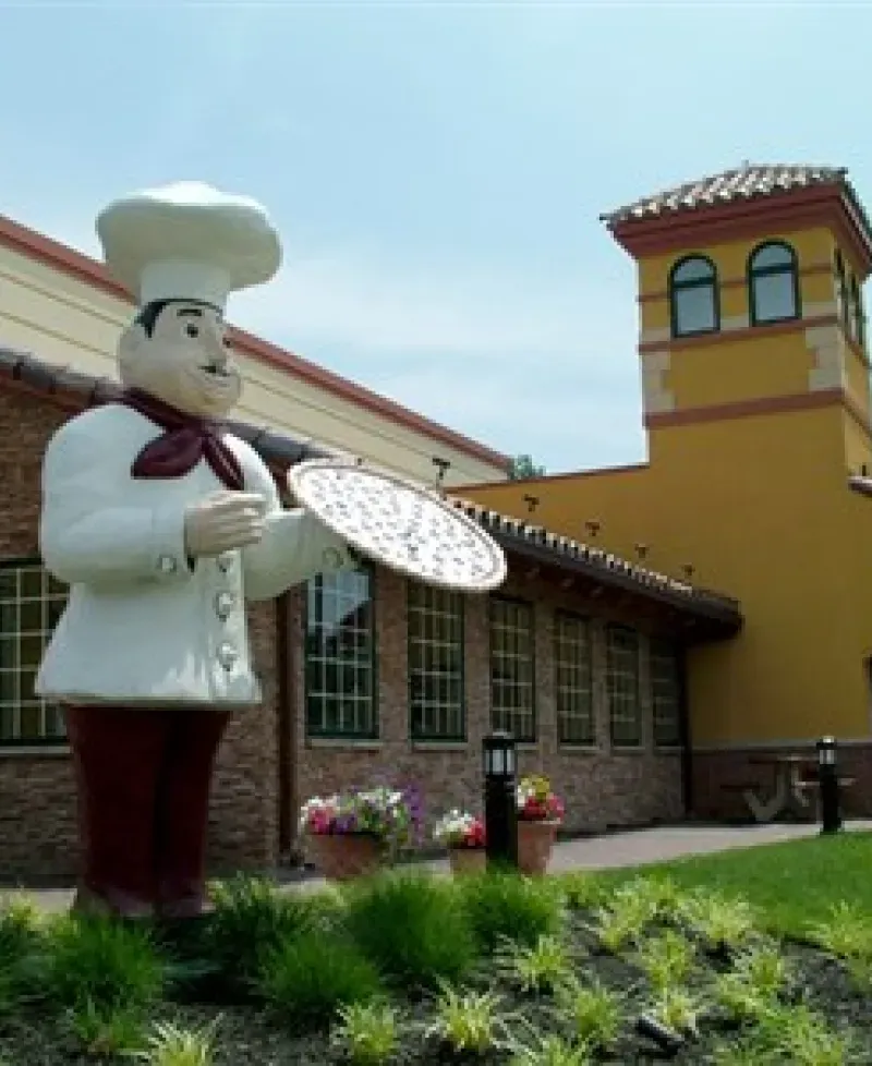 The iconic pizza man has been standing tall since 1977. Photo