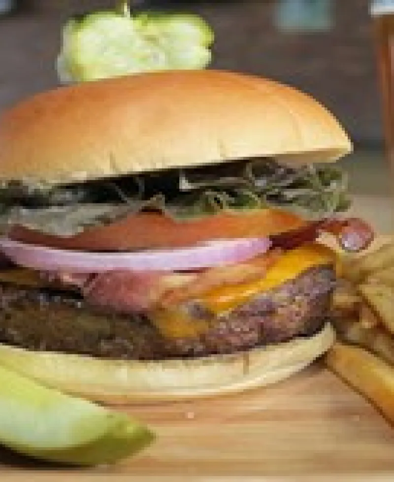 Loaded burger, fries and a pickle Photo