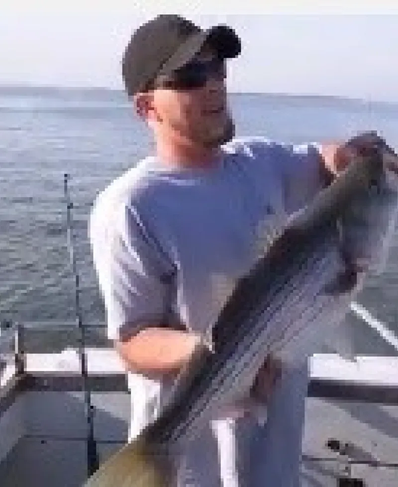 Man holding up a quality fish Photo
