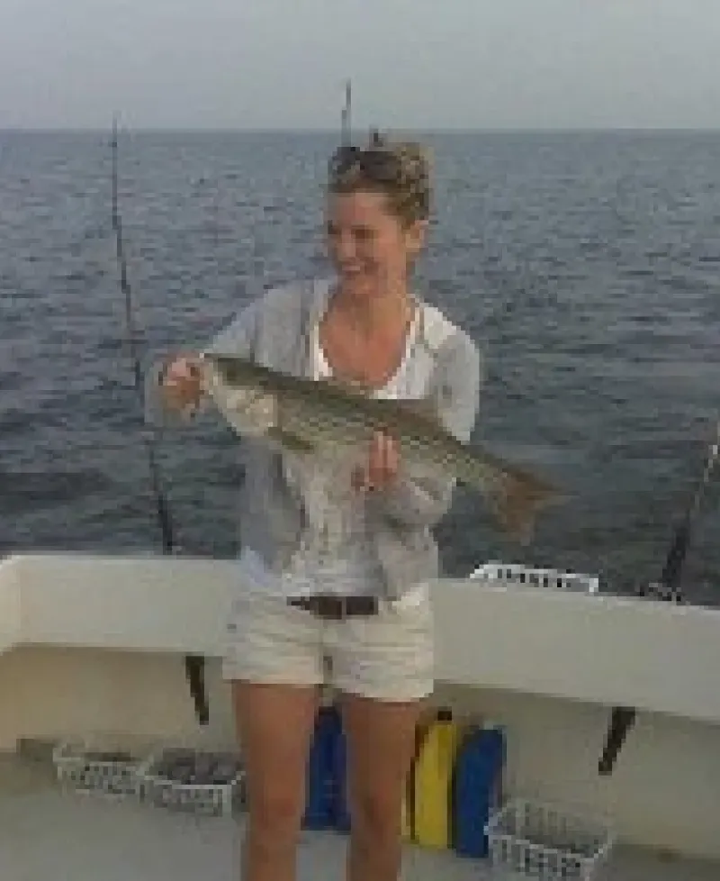 Angler proudly holding catch aboard Carlton Edwards Charter Photo