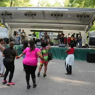 A group of people dancing to music.  Photo
