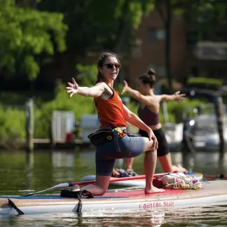 Person doing yoga on a paddleboard. Photo