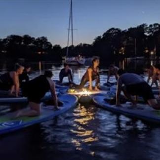 Yoga on paddleboards under the moonlight Photo