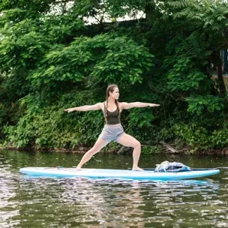 Person doing yoga on a paddleboard Photo