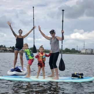 family paddling on paddleboards Photo