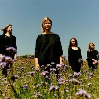 Four people in a field of purplse flowers Photo