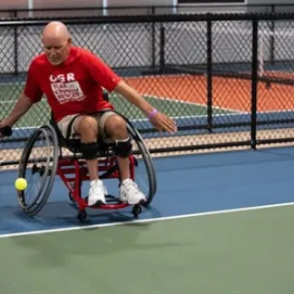 Pickleball for All participant playing in an adaptive game. Photo