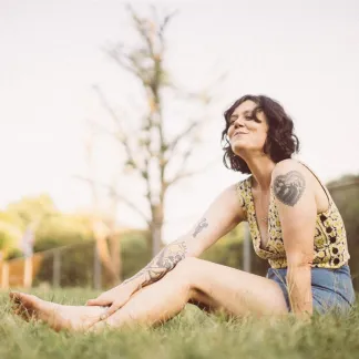 Woman sitting in a field Photo