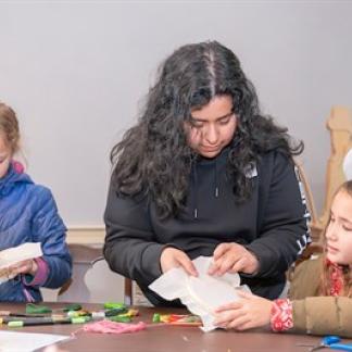 Three girls knitting.  Photo