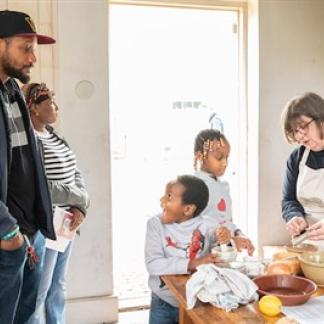 Children and parents participating in a Kitchen Guild activity. Photo