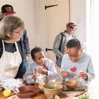Woman and children cooking. Photo