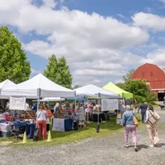First Sunday farmers market with tents and barn Photo