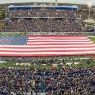 American flag in a full Navy stadium Photo