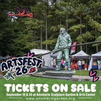 The Tonger statue at Artsfest with logo and event info Photo
