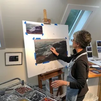 Artist Mary Pritchard at her easel. Photo