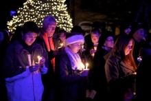 A group of attendees participating in the candle-lighting ceremony. Photo