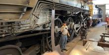 A Museum volunteer giving a restoration shop tour. Photo