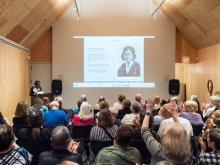A crowd listens to a lecture Photo
