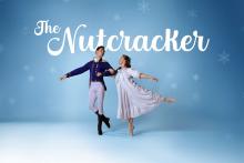 Two dancers posing with snowflakes in the background Photo