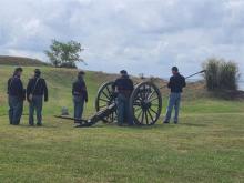 Artillery crew getting ready to fire a Civil War era cannon Photo