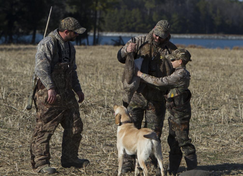 Family in camo with dog