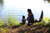 Mother and child fishing from a bank